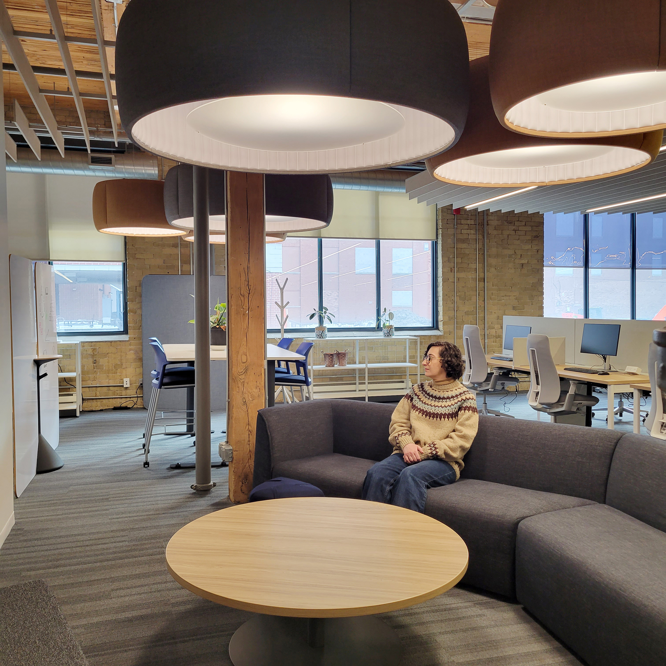 Woman sitting at soft seating area in GBC Future of Work